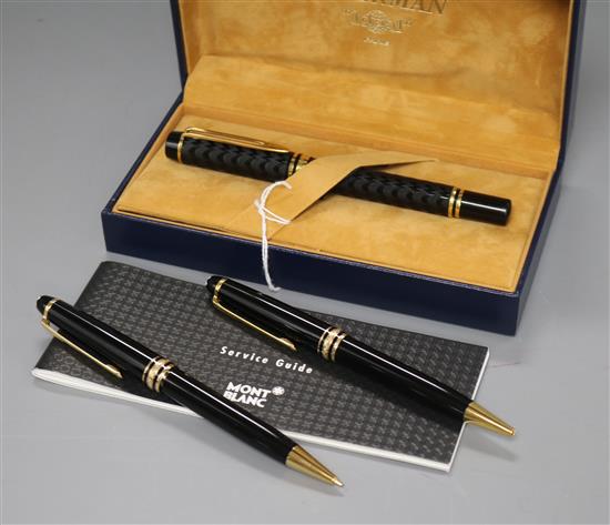 A Montblanc Meisterstuck black and gold ballpoint/propelling pencil set and a Waterman fountain pen